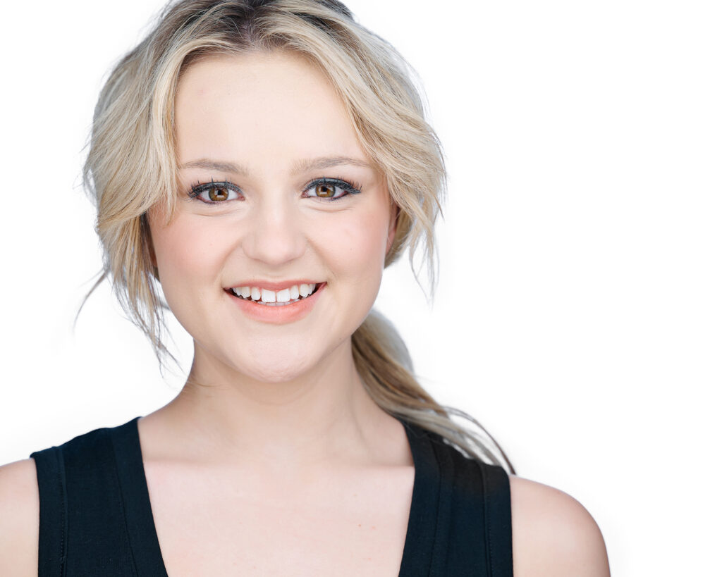Professional acting headshot of Sydney Hendrickson, a Nebraska college student and actor, photographed on a clean white background.