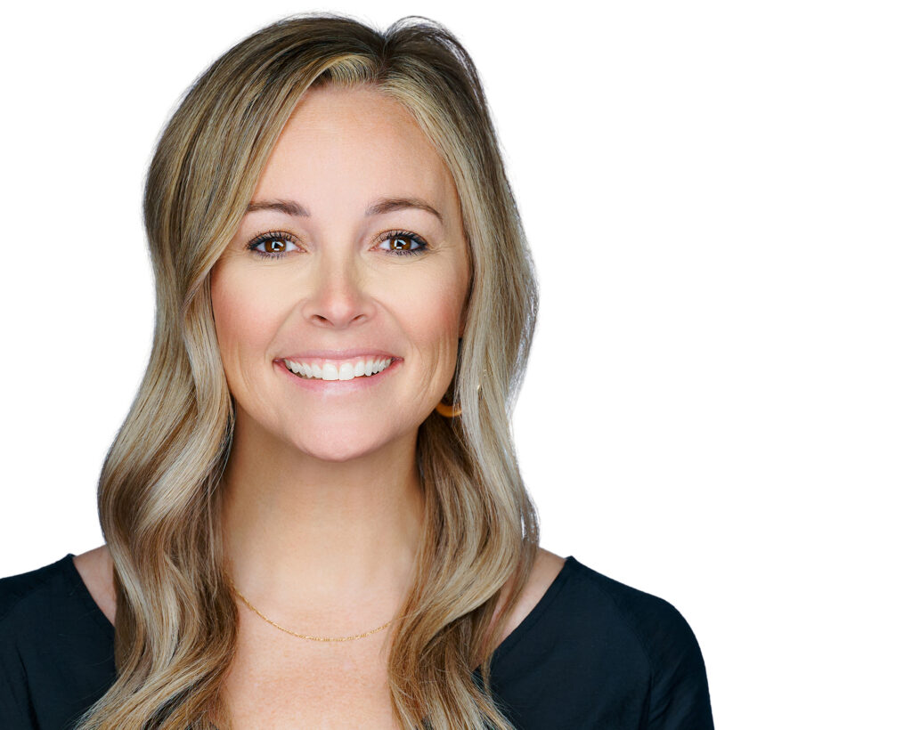 Professional LinkedIn headshot of a smiling woman on a clean white background in St. Louis