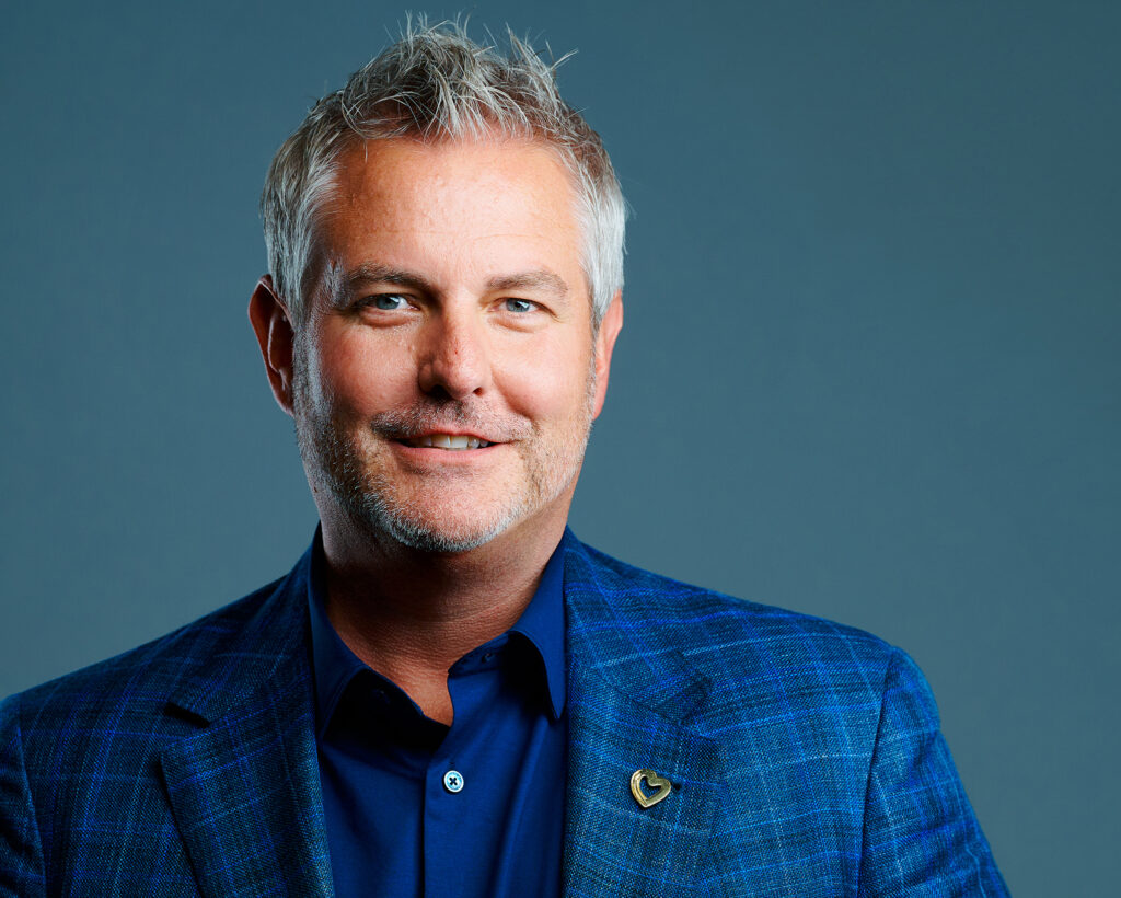 Executive headshot of a man in a blue blazer with modern studio lighting in St. Louis